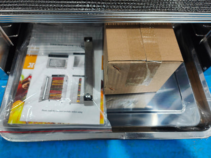 Stainless steel dehydrator tray area with booklet and cardboard inside unit