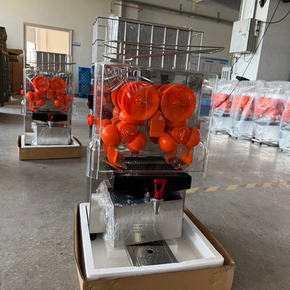 Automatic orange juicer machine with orange rollers, drip tray, and clear housing
