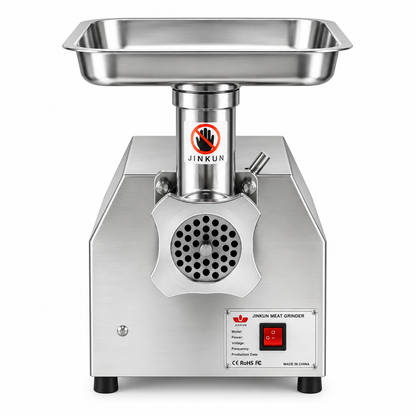 A stainless steel JINKUN electric meat grinder with a rectangular metal feed hopper on top, a cylindrical motor housing, a circular grinding opening with a black vented grille, and a front control panel with a red power switch.